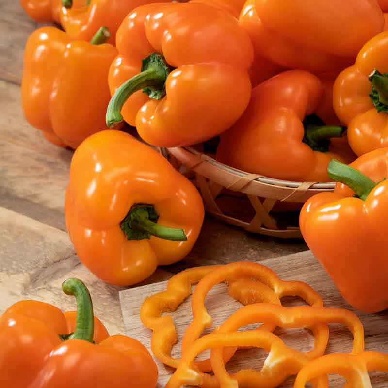 Bright Orange King bell pepper in a pile, ready for cooking. | copyright: Floramedia UK Ltd