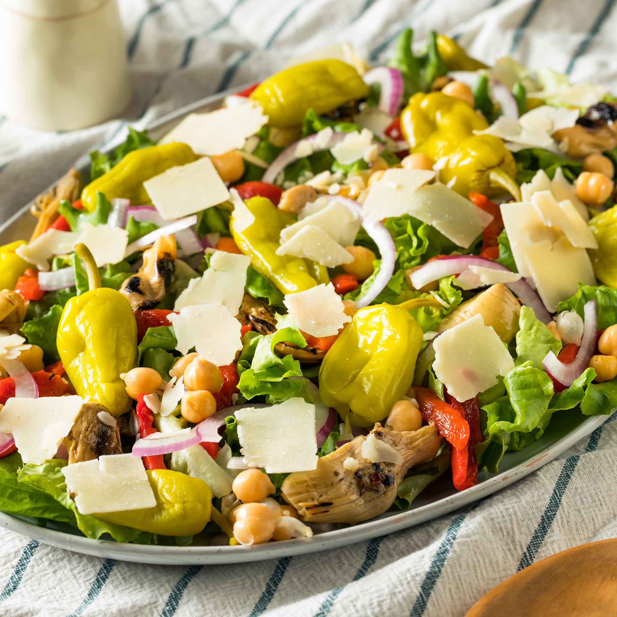 A coloful salad with Pepperoncini Italian peppers showcased.