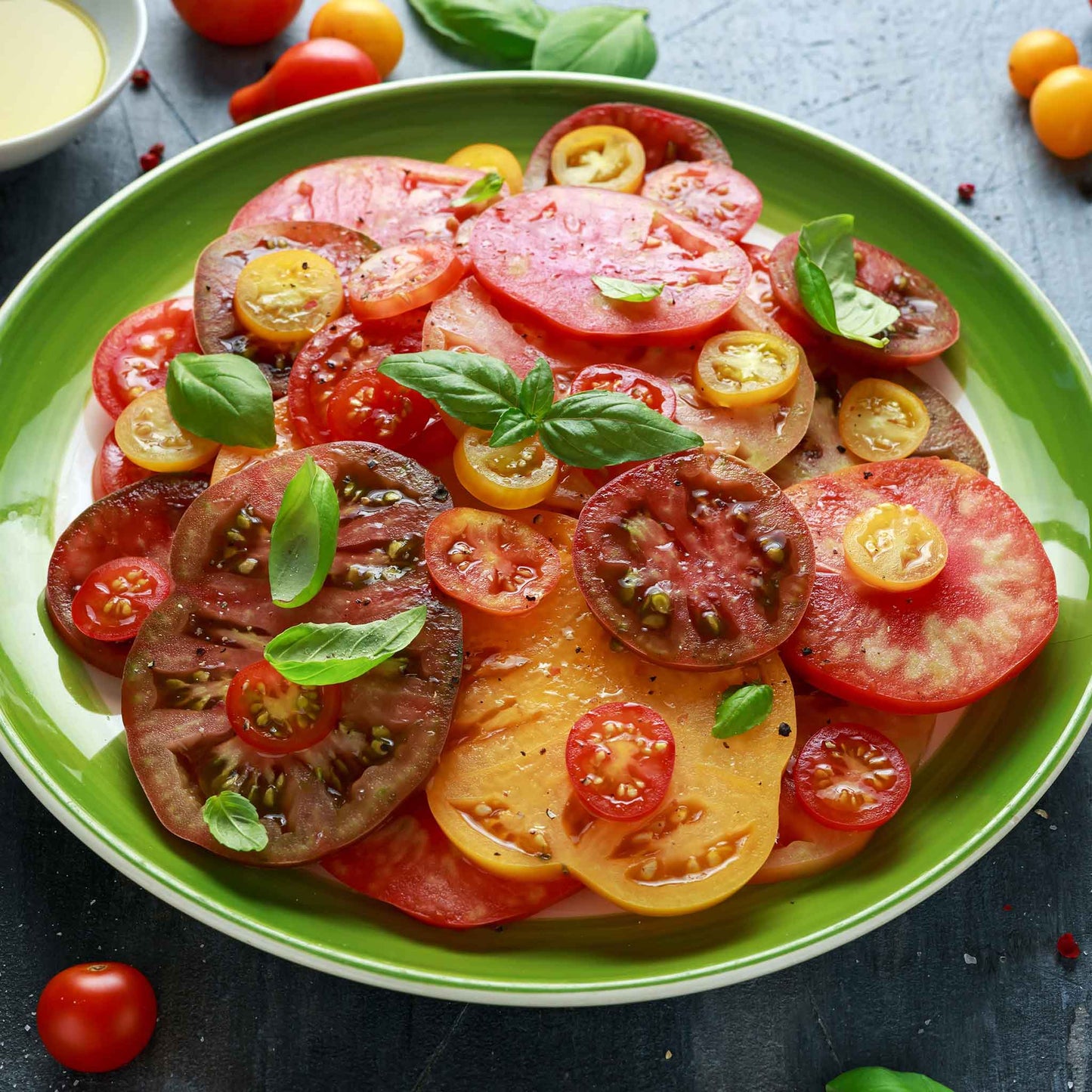 A plate of sliced Heirloom Rainbow tomatoes both large and small.