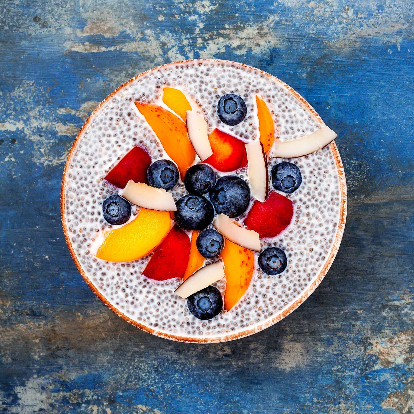 Close-up of a fruit bowl with chia seeds in yogurt.