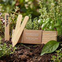 Bamboo seed labels for basil with a box of Eden Brothers bamboo seed labels in a garden setting.