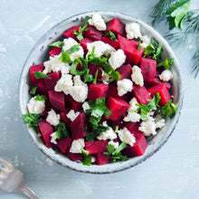 A bowl of salad with chopped ruby queen beets ready to eat.