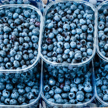 Harvested top hat blueberries gathered and in several bowls