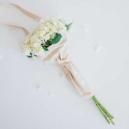 White flowers in the bouqbags gifting tote with strap on a white background
