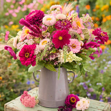 Bouquet of colorful flowers from the raspberry spritz bouquet in a metal vase with a garden background