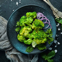 A plate of cooked calabrese broccoli florets ready to eat.