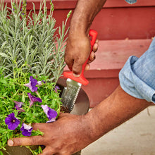 Person using a ComfortGel hori hori garden knife in a potted plant