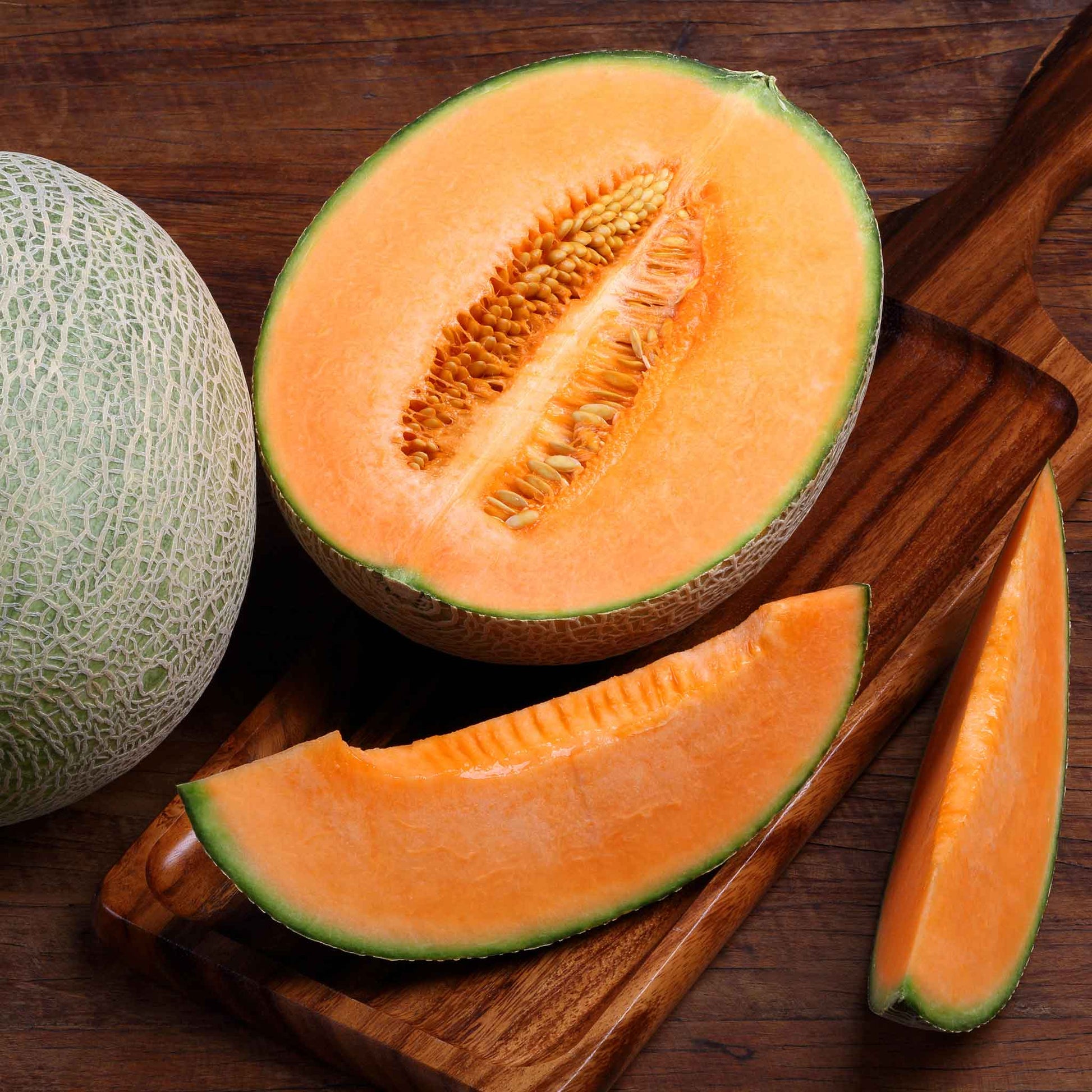 Edisto 47 melon cut open showing vibrant orange flesh and seedy center.