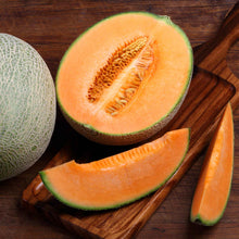 Edisto 47 melon cut open showing vibrant orange flesh and seedy center.