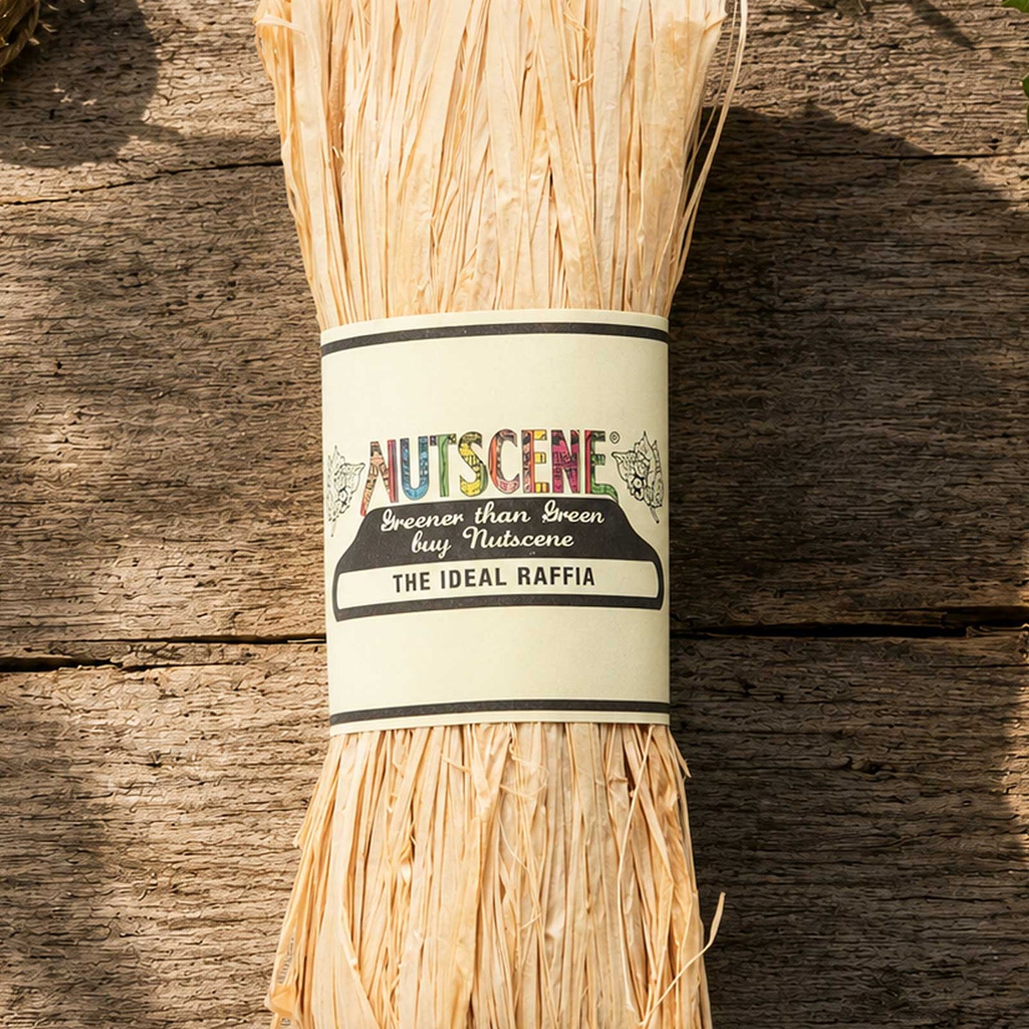 A bundle of the natural nutscene madagascan raffia with nutscene label on a wooden background