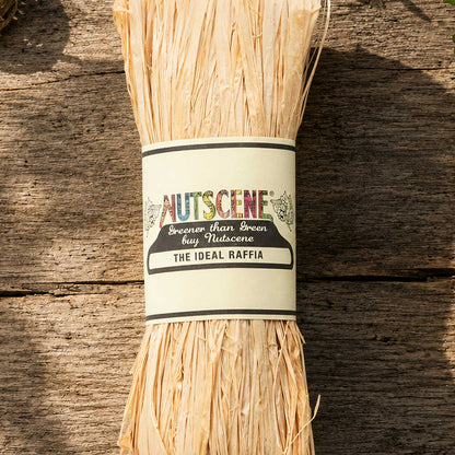 A bundle of the natural nutscene madagascan raffia with nutscene label on a wooden background