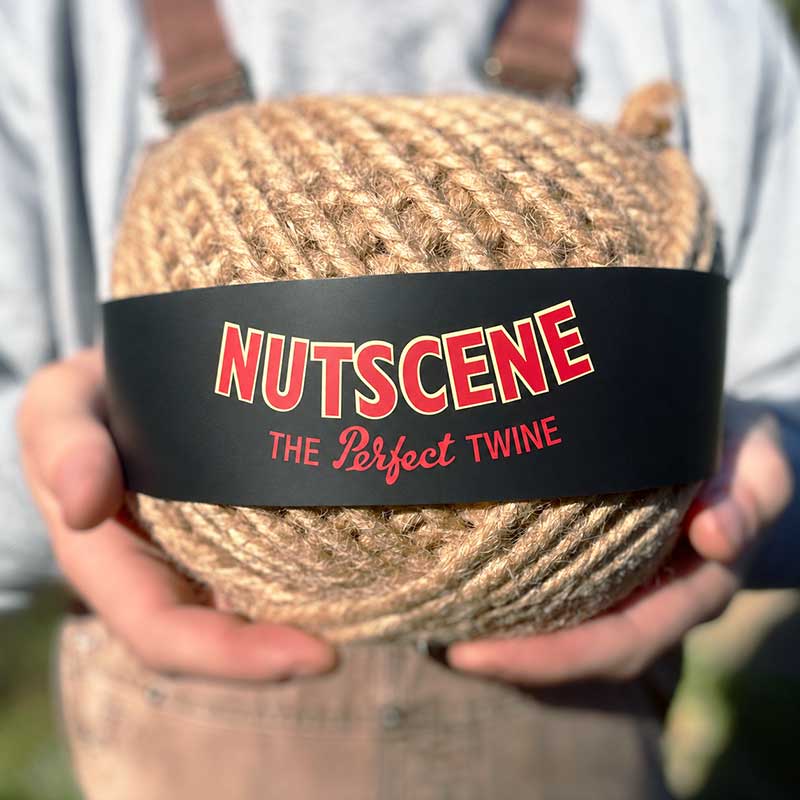 Person holding nutscene thick chunky twine ball with the label pointing outward.