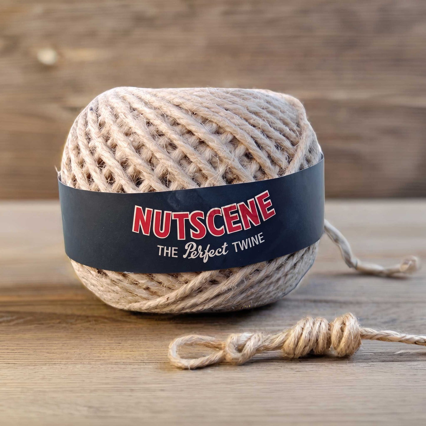 A ball of nutscene twine with black label on a wooden background