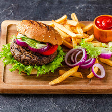 A platter of burger and fries showing sliced Red Burgundy onions on and off the burger.