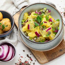 A garden salad using Ruby Red onions chopped up.