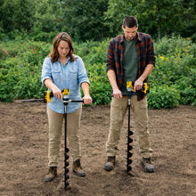 Two people using the power planter bulb planting auger extended length in a garden patch