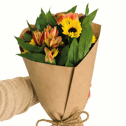 Recycled brown paper flower wraps shown in use around a floral arrangement tied with twine