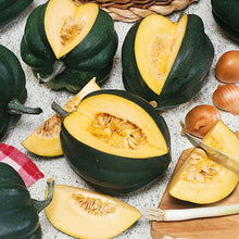 Table King Bush squash with section cut out showing inside flesh and seeds.