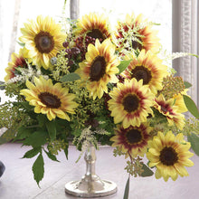 Bright marley sunflower bloom with vibrant yellow petals and dark center outdoors