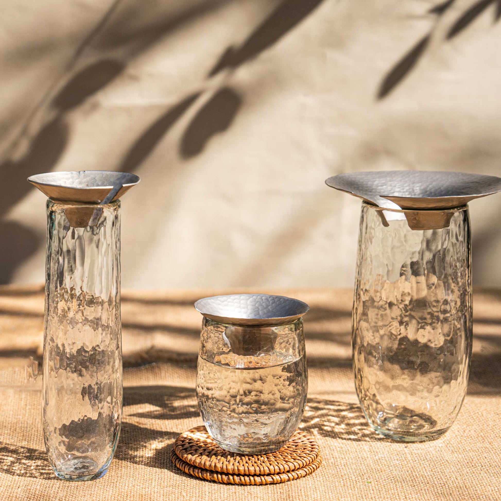 The collective Floral Propagation vases showing the various sizes of clear pebbled glass with metal stem holders