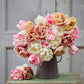 A person holding a pink, orange, and yellow bouquet from the antique cameo tulip bundle