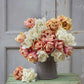 A person holding a pink and yellow bouquet from the la belle epoque and mount tacoma tulip bundle