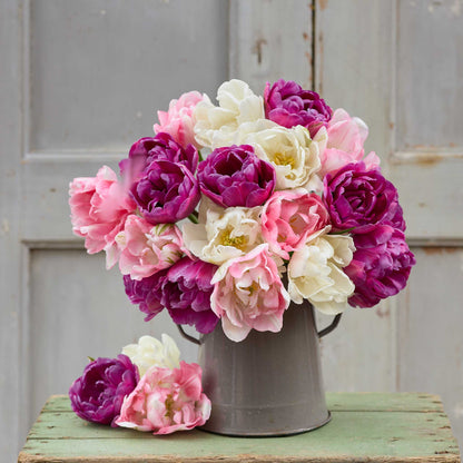 A vase holding a pink and yellow bouquet from the vintage vanity tulip bundle