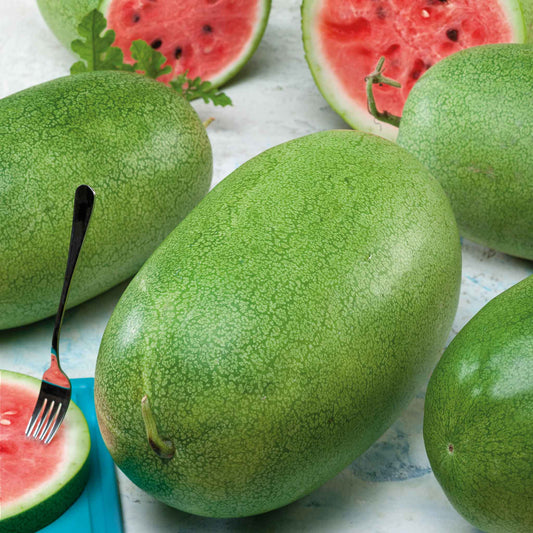 A Charleston Grey watermelon with a cross section showing red flesh and black seeds in the background.