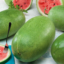 A Charleston Grey watermelon with a cross section showing red flesh and black seeds in the background.
