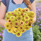 A person holding a bouquet of the zinnia bundle queeny sunset in a garden setting