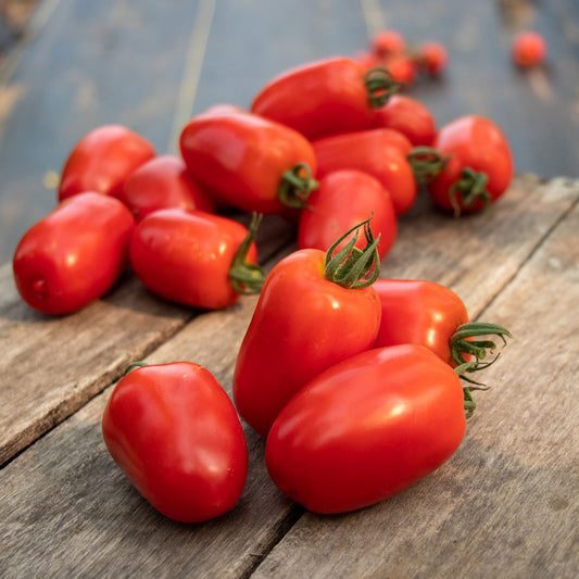 A bunch of Trutti-Fruiit Paprika tomatoes showing their oblong shape on a wooden background.